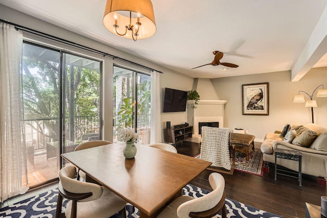 606 W Lynn St Unit 16, Austin, TX 78703 - dining space with a large fireplace, wood finished floors, and ceiling fan