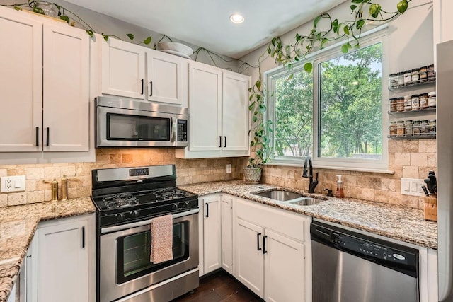 606 W Lynn St Unit 16, Austin, TX 78703 - kitchen with stainless steel appliances, a sink, white cabinetry, healthy amount of natural light, and recessed lighting