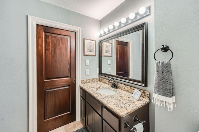 606 W Lynn St Unit 16, Austin, TX 78703 - bathroom with vanity, tile patterned floors, and a textured wall