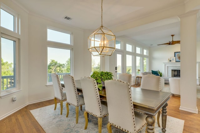 5801 Fox Chapel Dr, Austin, TX 78746 - dining room with ornamental molding, wood finished floors, a high end fireplace, baseboards, and a chandelier
