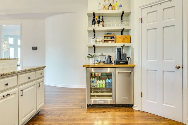 5801 Fox Chapel Dr, Austin, TX 78746 - indoor dry bar with beverage cooler and light wood finished floors