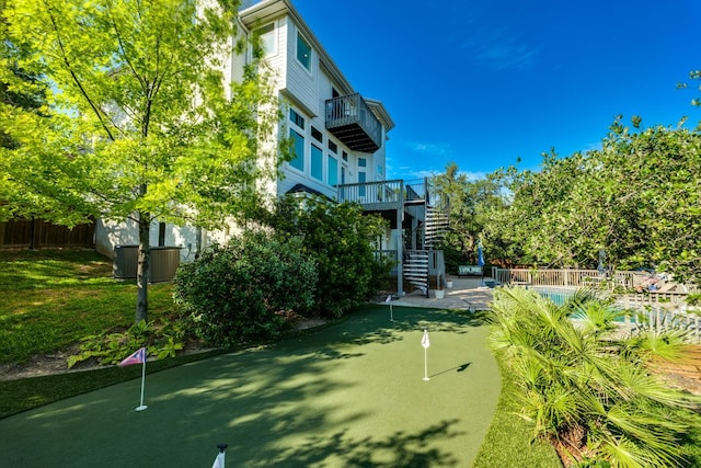 5801 Fox Chapel Dr, Austin, TX 78746 - view of property's community featuring a putting area, stairs, a pool, and a patio