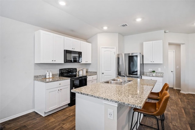 6100 Shanjia Dr, Austin, TX 78724 - kitchen with black appliances, a sink, dark wood finished floors, baseboards, and an island with sink