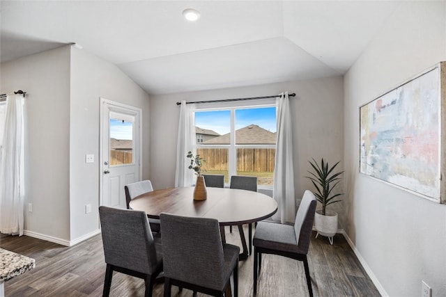 6100 Shanjia Dr, Austin, TX 78724 - dining area with lofted ceiling, dark wood-style floors, and baseboards