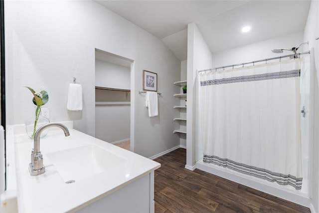 6100 Shanjia Dr, Austin, TX 78724 - full bathroom featuring a shower with curtain, wood finished floors, baseboards, vanity, and a spacious closet