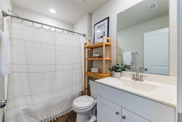 6100 Shanjia Dr, Austin, TX 78724 - full bathroom with toilet, vanity, wood finished floors, recessed lighting, and a shower with shower curtain