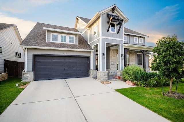 817 Craven Hill Ln, Leander, TX 78641 - view of front facade with stone siding, board and batten siding, concrete driveway, and a front yard