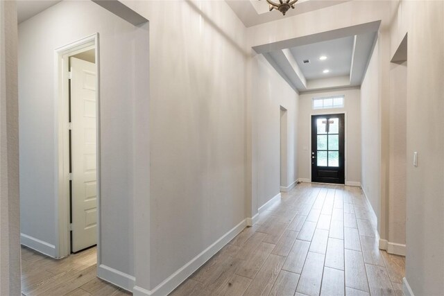 817 Craven Hill Ln, Leander, TX 78641 - foyer entrance with light wood finished floors, a raised ceiling, baseboards, and recessed lighting