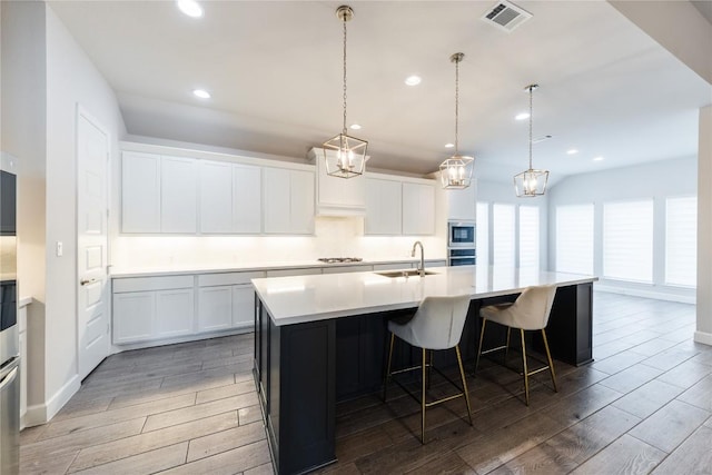 817 Craven Hill Ln, Leander, TX 78641 - kitchen featuring a sink, light wood finished floors, an island with sink, recessed lighting, and stainless steel appliances