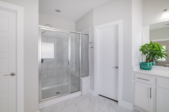 132 Lockhart Dr, Liberty Hill, TX 78642 - bathroom with a marble finish shower, vanity, marble look tile flooring, baseboards, and healthy amount of natural light