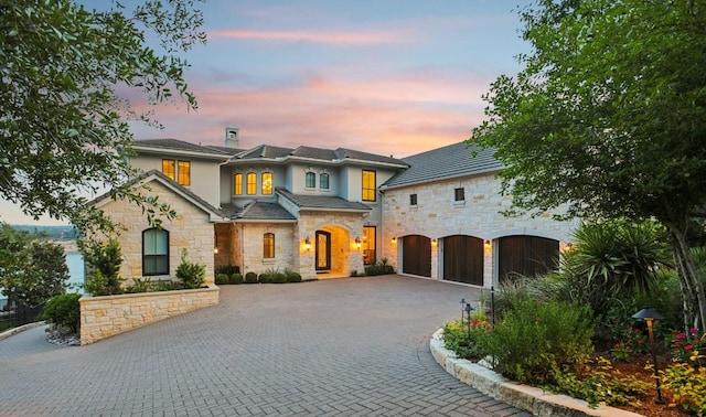 1353 Osprey Ridge Loop, Lago Vista, TX 78645 - view of front of home featuring stone siding, curved driveway, and stucco siding