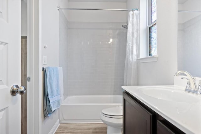 7818 Moody Bnd, Austin, TX 78744 - bathroom with vanity, wood finished floors, shower / tub combo, and toilet