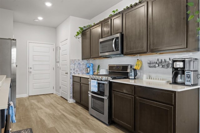 7818 Moody Bnd, Austin, TX 78744 - kitchen featuring appliances with stainless steel finishes, dark brown cabinetry, tasteful backsplash, light countertops, and light wood-style flooring