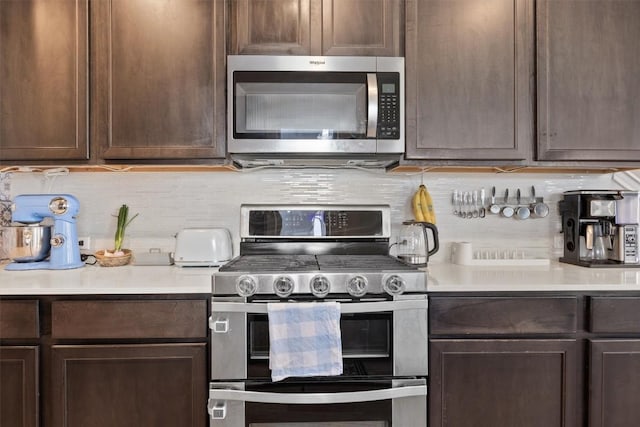 7818 Moody Bnd, Austin, TX 78744 - kitchen with appliances with stainless steel finishes, decorative backsplash, light countertops, and dark brown cabinets