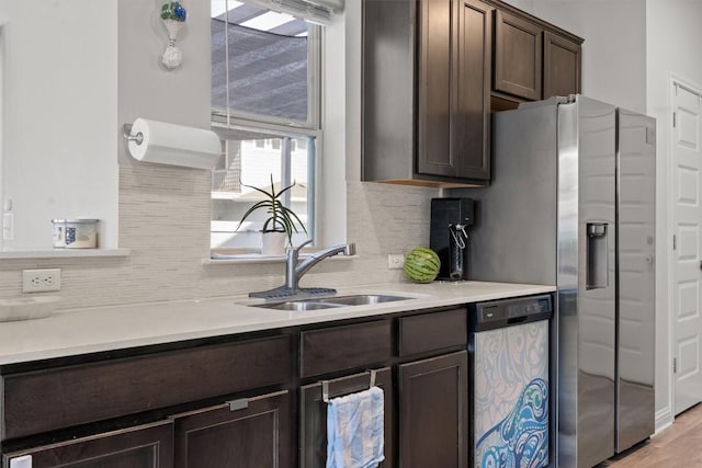 7818 Moody Bnd, Austin, TX 78744 - kitchen with stainless steel appliances, dark brown cabinetry, backsplash, a sink, and light countertops