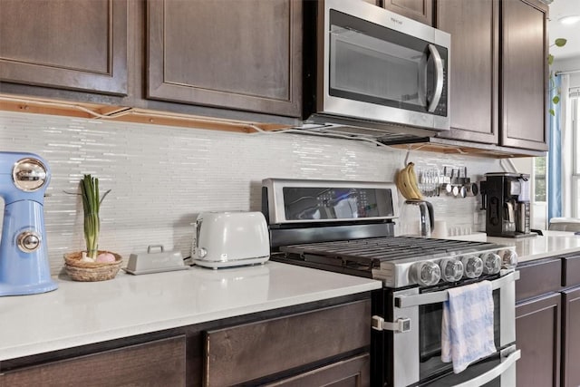 7818 Moody Bnd, Austin, TX 78744 - kitchen featuring appliances with stainless steel finishes, dark brown cabinets, decorative backsplash, and light countertops