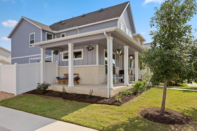 7818 Moody Bnd, Austin, TX 78744 - view of front facade featuring covered porch, brick siding, board and batten siding, and roof with shingles