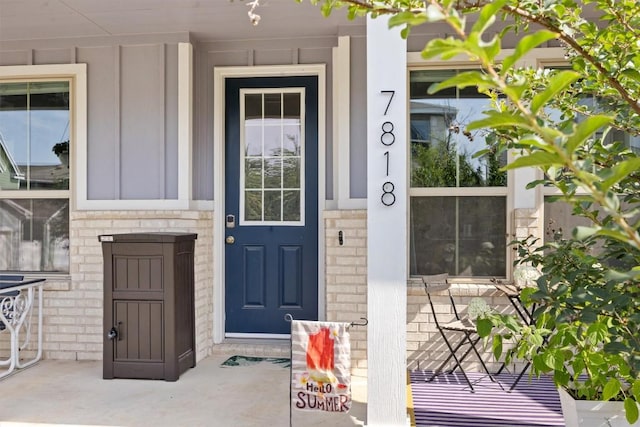 7818 Moody Bnd, Austin, TX 78744 - entrance to property with board and batten siding, brick siding, and a porch
