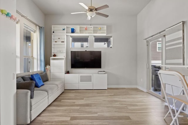 7818 Moody Bnd, Austin, TX 78744 - living room featuring a ceiling fan, light wood-style floors, and baseboards