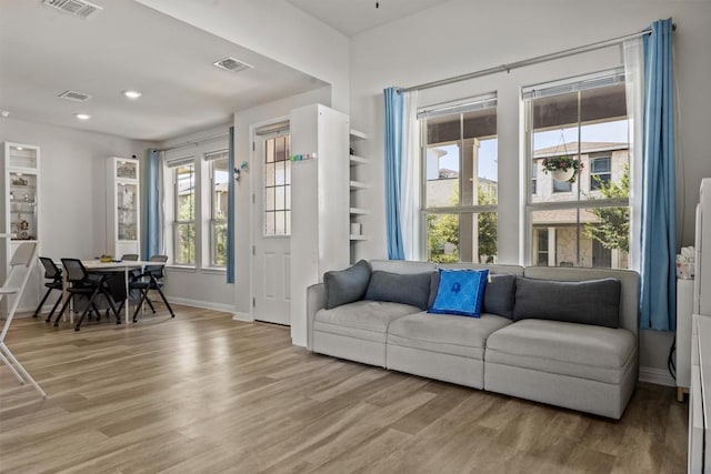 7818 Moody Bnd, Austin, TX 78744 - living room with light wood-style floors, baseboards, and recessed lighting