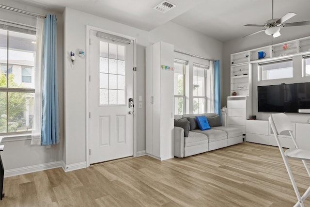 7818 Moody Bnd, Austin, TX 78744 - living area featuring light wood finished floors, ceiling fan, and baseboards