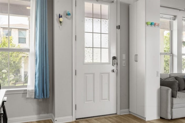 7818 Moody Bnd, Austin, TX 78744 - doorway with baseboards and wood finished floors