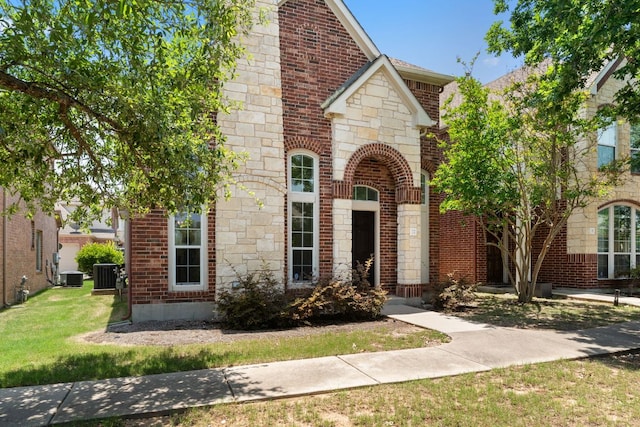 14812 Avery Ranch Blvd Unit 72, Austin, TX 78717 - french country home featuring cooling unit, brick siding, a front yard, and stone siding