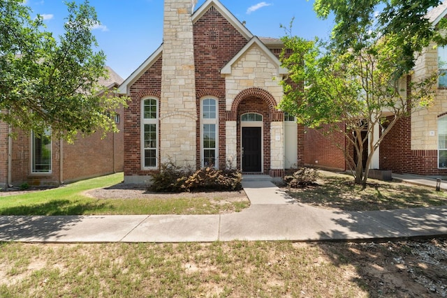 14812 Avery Ranch Blvd Unit 72, Austin, TX 78717 - view of front of property with a chimney, brick siding, stone siding, and a front lawn