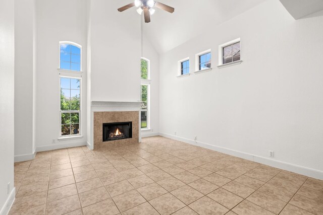 14812 Avery Ranch Blvd Unit 72, Austin, TX 78717 - unfurnished living room with high vaulted ceiling, a ceiling fan, light tile patterned floors, a tile fireplace, and baseboards
