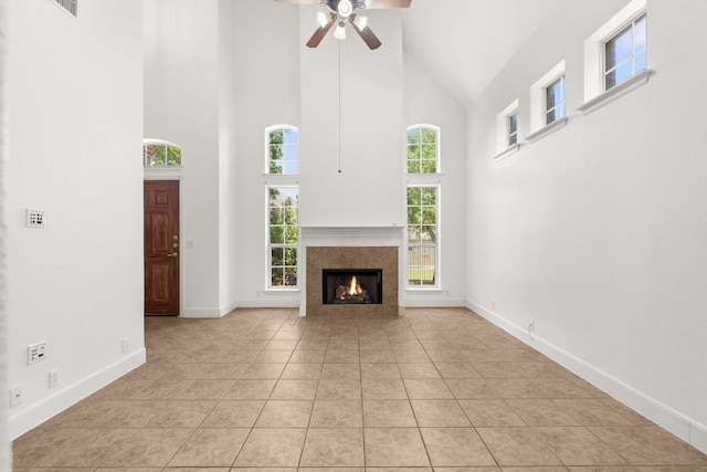 14812 Avery Ranch Blvd Unit 72, Austin, TX 78717 - unfurnished living room with high vaulted ceiling, ceiling fan, light tile patterned floors, a tile fireplace, and baseboards
