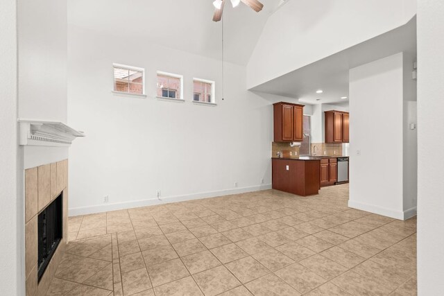 14812 Avery Ranch Blvd Unit 72, Austin, TX 78717 - unfurnished living room with a sink, a tile fireplace, ceiling fan, light tile patterned floors, and baseboards