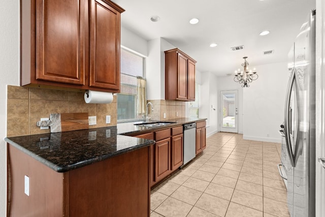 14812 Avery Ranch Blvd Unit 72, Austin, TX 78717 - kitchen with appliances with stainless steel finishes, a chandelier, light tile patterned flooring, tasteful backsplash, and baseboards