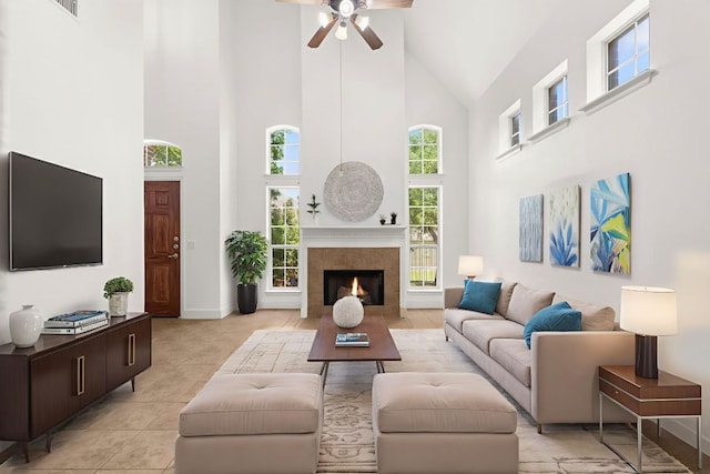14812 Avery Ranch Blvd Unit 72, Austin, TX 78717 - living area with high vaulted ceiling, ceiling fan, light tile patterned floors, a tiled fireplace, and baseboards