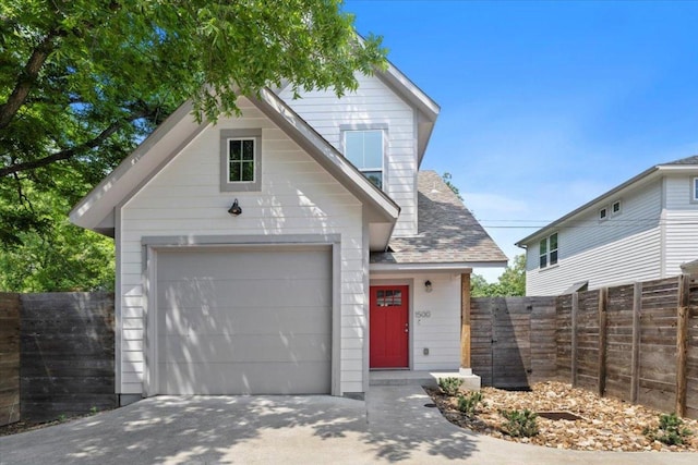 1500 Justin Ln Unit 2, Austin, TX 78757 - view of front facade with driveway, a garage, and roof with shingles
