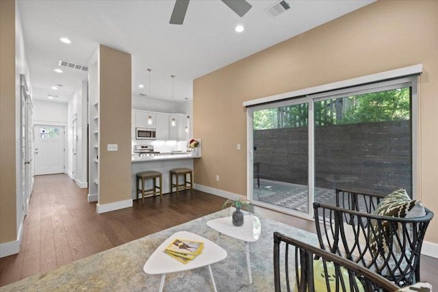 1500 Justin Ln Unit 2, Austin, TX 78757 - living room with baseboards, wood finished floors, healthy amount of natural light, a ceiling fan, and recessed lighting