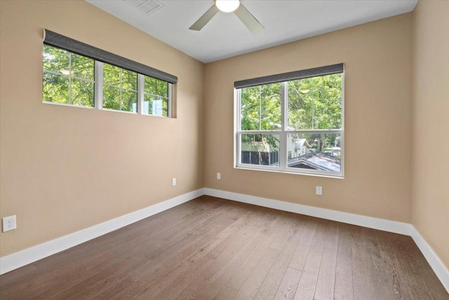 1500 Justin Ln Unit 2, Austin, TX 78757 - empty room featuring baseboards, healthy amount of natural light, hardwood / wood-style floors, and a ceiling fan