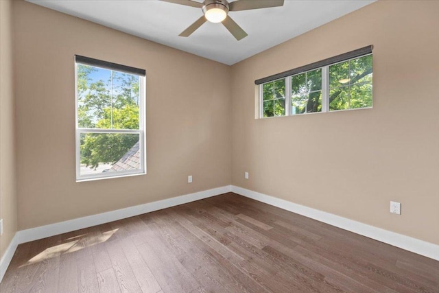 1500 Justin Ln Unit 2, Austin, TX 78757 - spare room featuring healthy amount of natural light, baseboards, and dark wood-style flooring