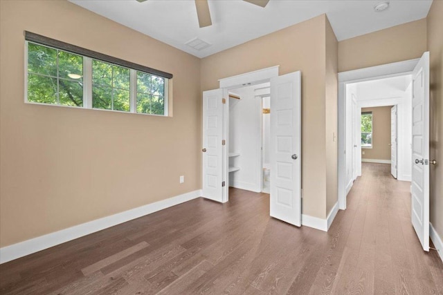 1500 Justin Ln Unit 2, Austin, TX 78757 - unfurnished bedroom featuring dark wood finished floors, baseboards, and ceiling fan
