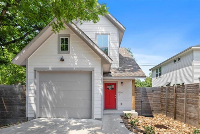 1500 Justin Ln Unit 2, Austin, TX 78757 - view of front facade featuring a garage, concrete driveway, and a shingled roof