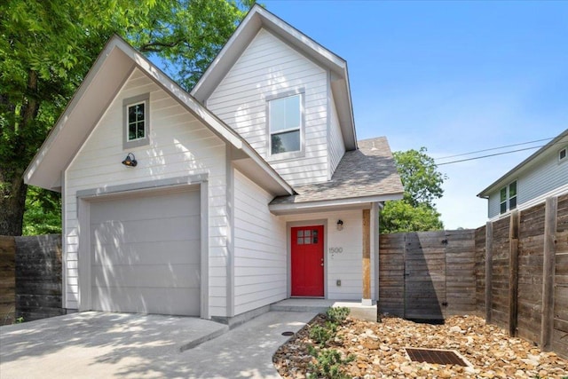 1500 Justin Ln Unit 2, Austin, TX 78757 - view of front of property featuring a garage and roof with shingles