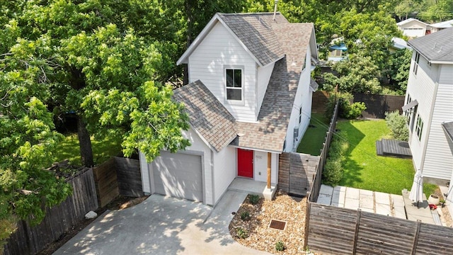 1500 Justin Ln Unit 2, Austin, TX 78757 - view of front of house featuring roof with shingles, driveway, and an attached garage