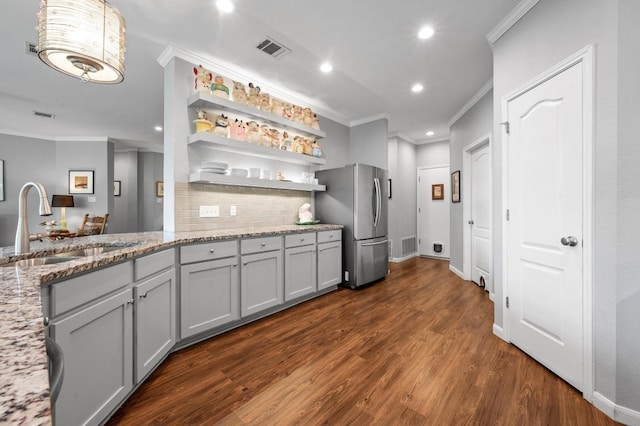 4600 Tello Path, Austin, TX 78749 - kitchen with freestanding refrigerator, ornamental molding, a sink, backsplash, and gray cabinets