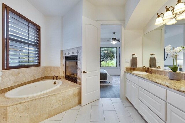 13601 Montview Dr, Austin, TX 78732 - full bathroom with ensuite bathroom, vanity, a bath, a ceiling fan, and tile patterned floors