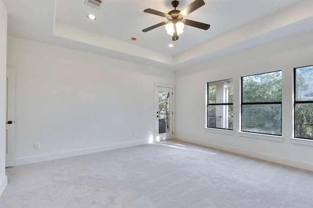 13601 Montview Dr, Austin, TX 78732 - empty room with light carpet, a tray ceiling, a ceiling fan, and recessed lighting