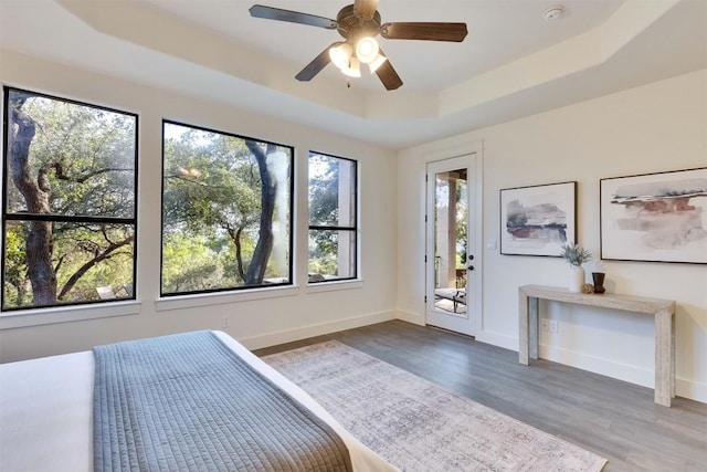 13601 Montview Dr, Austin, TX 78732 - bedroom with a raised ceiling, wood finished floors, access to outside, and ceiling fan