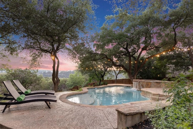 13601 Montview Dr, Austin, TX 78732 - pool at dusk featuring an in-ground hot tub, a patio, an outdoor pool, and a fenced backyard