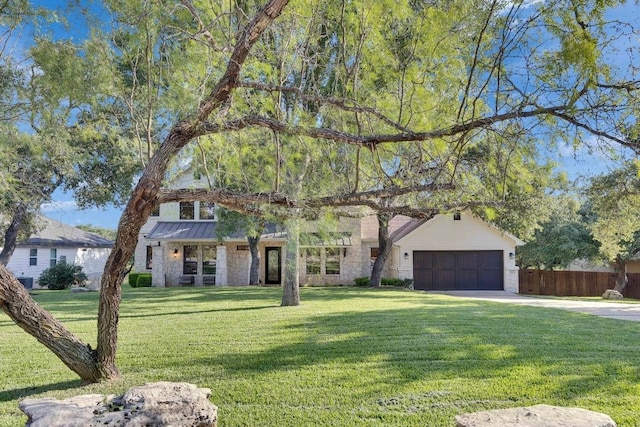 13601 Montview Dr, Austin, TX 78732 - view of front of house featuring driveway, a garage, a standing seam roof, and stone siding