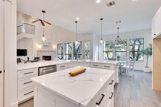 13601 Montview Dr, Austin, TX 78732 - kitchen featuring dishwasher, ceiling fan, a sink, a fireplace, and light wood-style floors