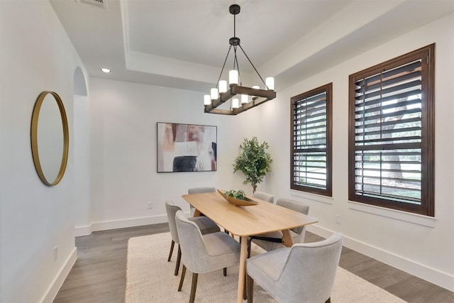 13601 Montview Dr, Austin, TX 78732 - dining room with dark wood-style flooring, a tray ceiling, a chandelier, and recessed lighting