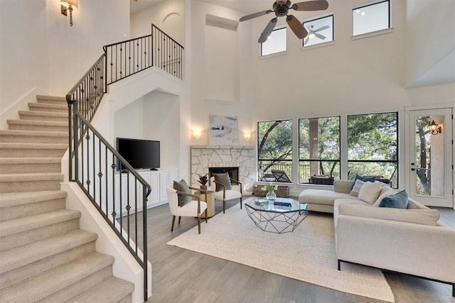 13601 Montview Dr, Austin, TX 78732 - living room with a towering ceiling, ceiling fan, plenty of natural light, wood finished floors, and stairway